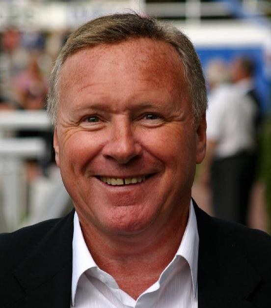 David Hamilton, smiling, in a dark jacket and open-collar shirt